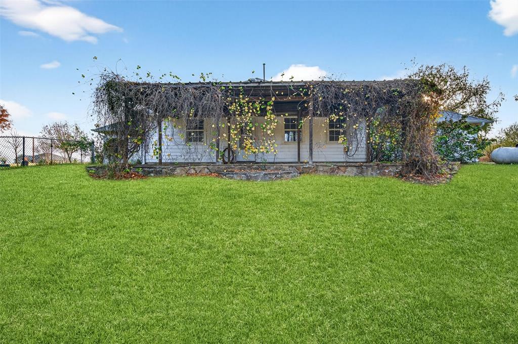 538 Lakewood Road Denison, TX 75020 - Photo 29 of 35 a view of a house with a big yard and large trees
