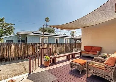 a view of a patio with couches chairs and a potted plant