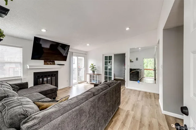 a living room with fireplace furniture and a flat screen tv