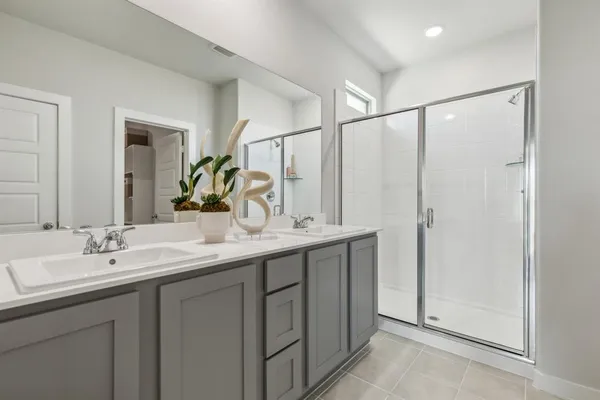 a bathroom with a double vanity sink and mirror