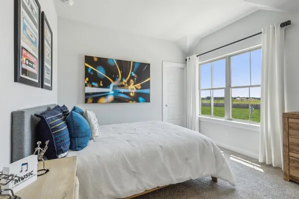 a bedroom with a large bed and a window