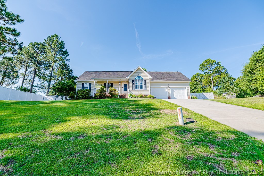 a view of a house with a backyard