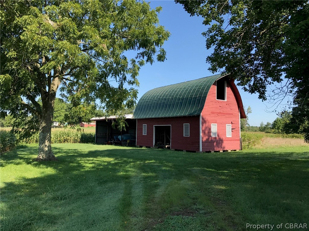 1943 Browns Store Road Heathsville, VA 22473 - Photo 5 of 6 Large barn to left of home with lean to off the side for more equipment storage.