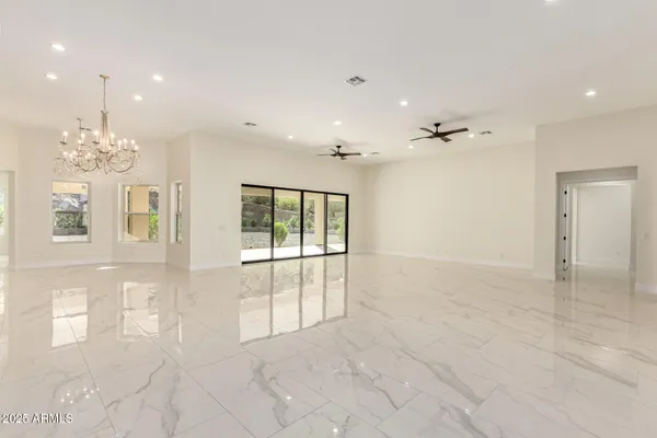 an empty room with windows and outdoor view