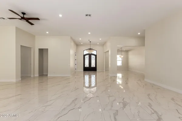 a large kitchen with stainless steel appliances lots of counter space and a sink