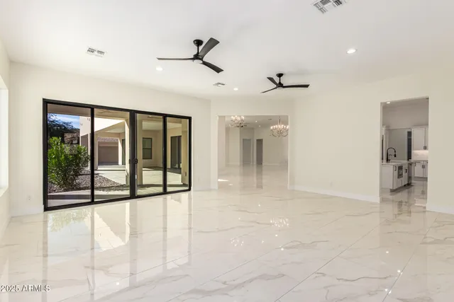 a view of a livingroom with a ceiling fan and window