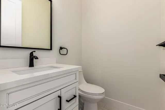 a spacious bathroom with a granite countertop sink mirror and bathtub