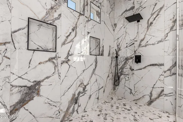 an empty room with a ceiling fan and carpet