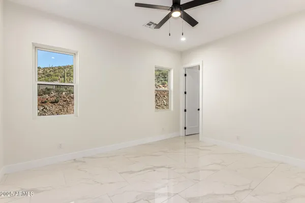 a view of walk in closet with empty racks