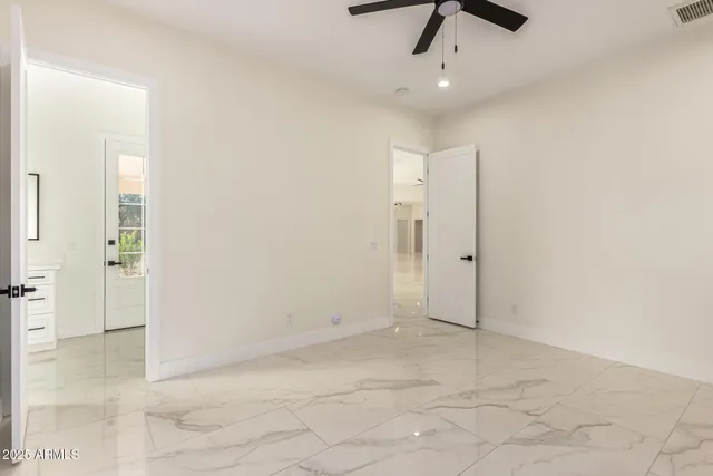 a view of a dry yard with wooden fence