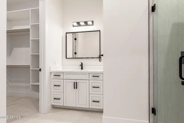 a view of a dry yard with wooden fence