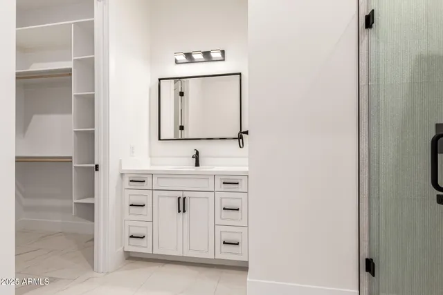 a view of a dry yard with wooden fence