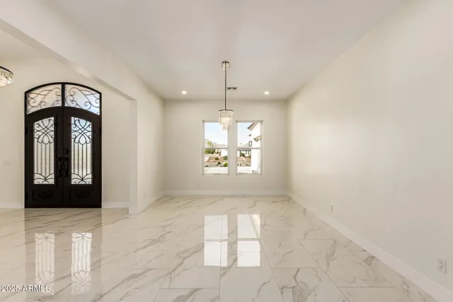 an empty room with windows and outdoor view