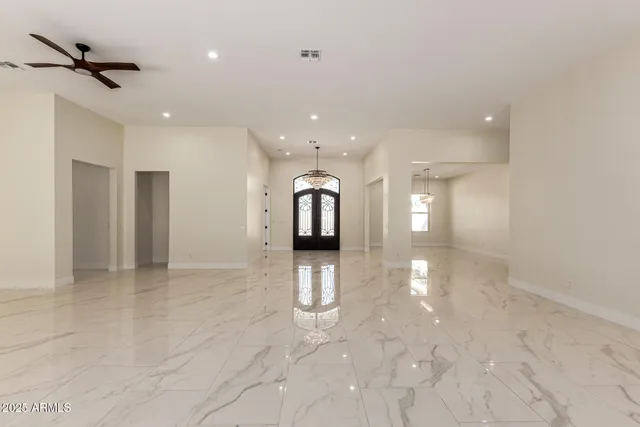 a view of an empty room with a chandelier