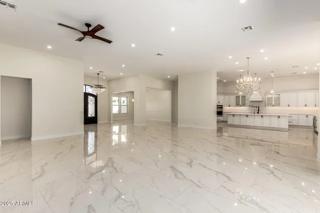 an empty room with windows and outdoor view