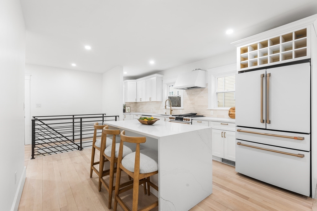 22 Prescott Street, Unit 1 Salem, MA 01970 - Photo 11 of 38 a kitchen with a sink a stove cabinets and wooden floor