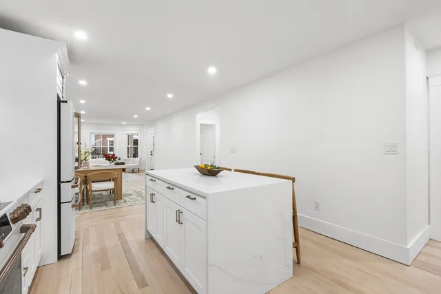 a kitchen with a stove and white cabinets