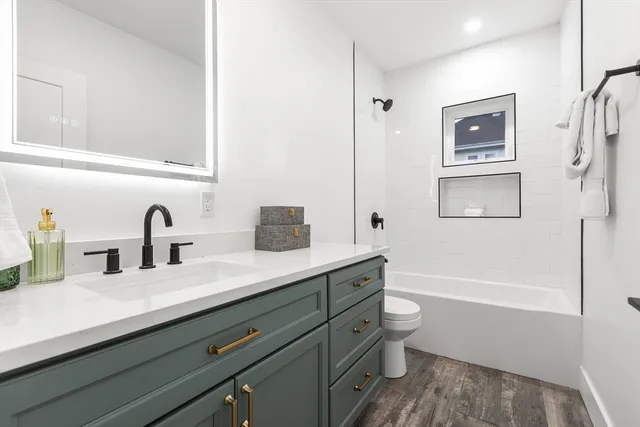 a bathroom with a double vanity sink and a bathtub