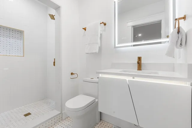 a bathroom with a sink toilet and shower