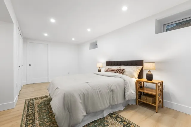 a bed room with a bed and a chair