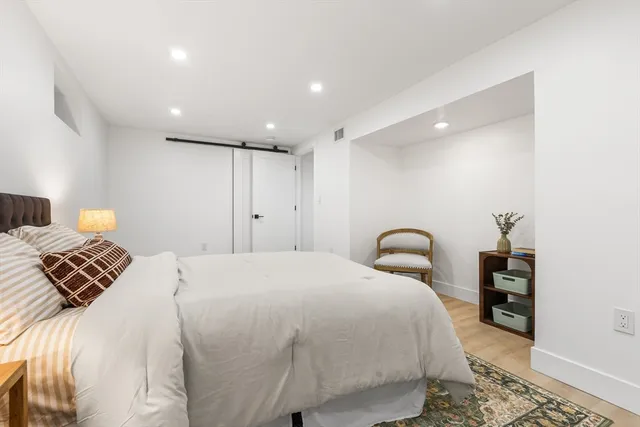 a bedroom with a bed and a lamp