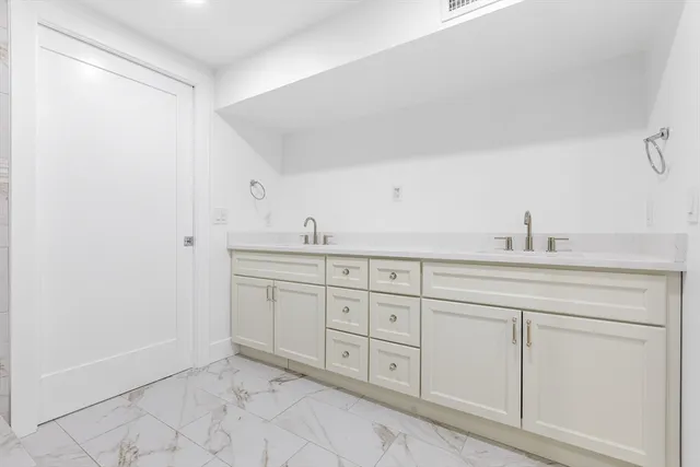 a spacious bathroom with a sink and a mirror