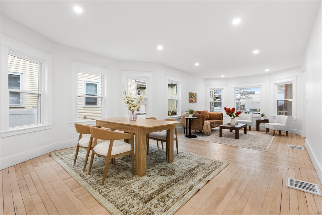 22 Prescott Street, Unit 1 Salem, MA 01970 - Photo 9 of 38 a living room with furniture a table and wooden floor