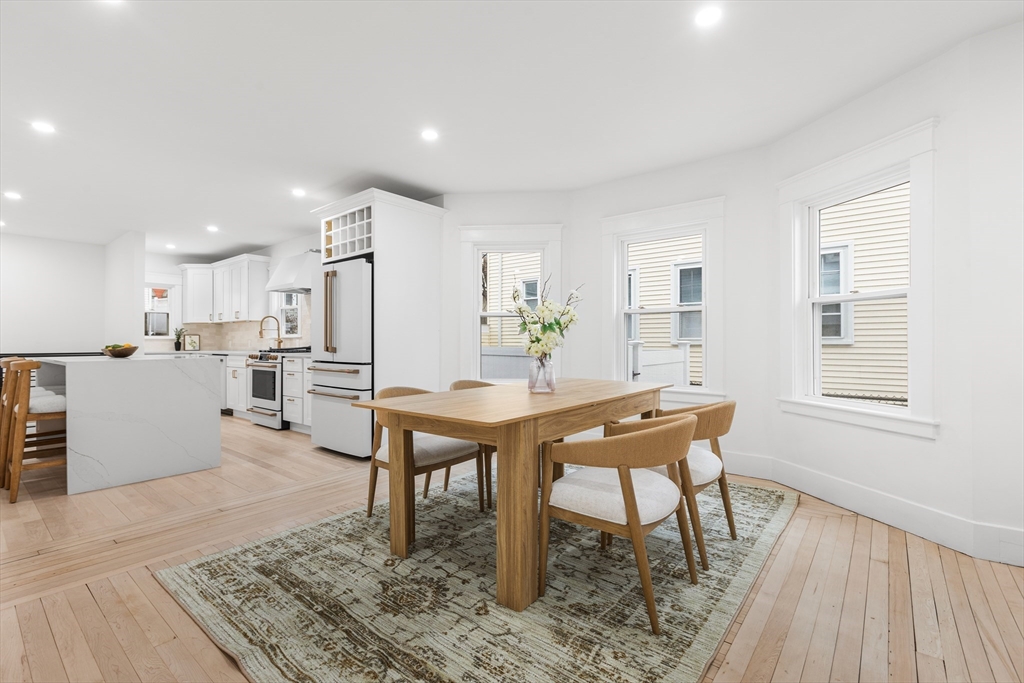 22 Prescott Street, Unit 1 Salem, MA 01970 - Photo 10 of 38 a room with stainless steel appliances kitchen island granite countertop furniture and a dining table