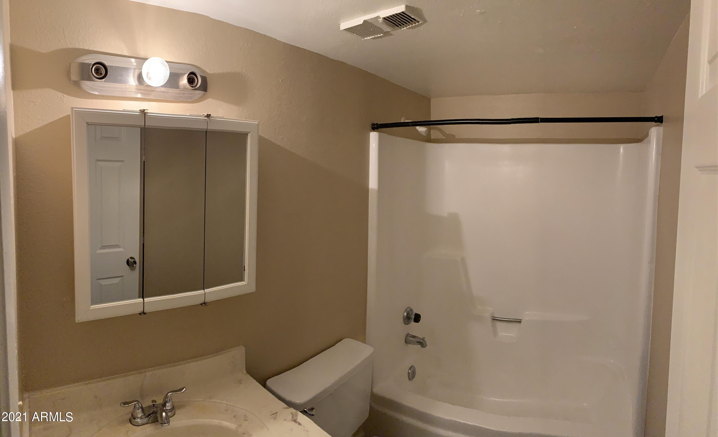 2217 East Cactus Road, Unit 4 Phoenix, AZ 85022 - Photo 11 of 14 a bathroom with a bathtub and shower