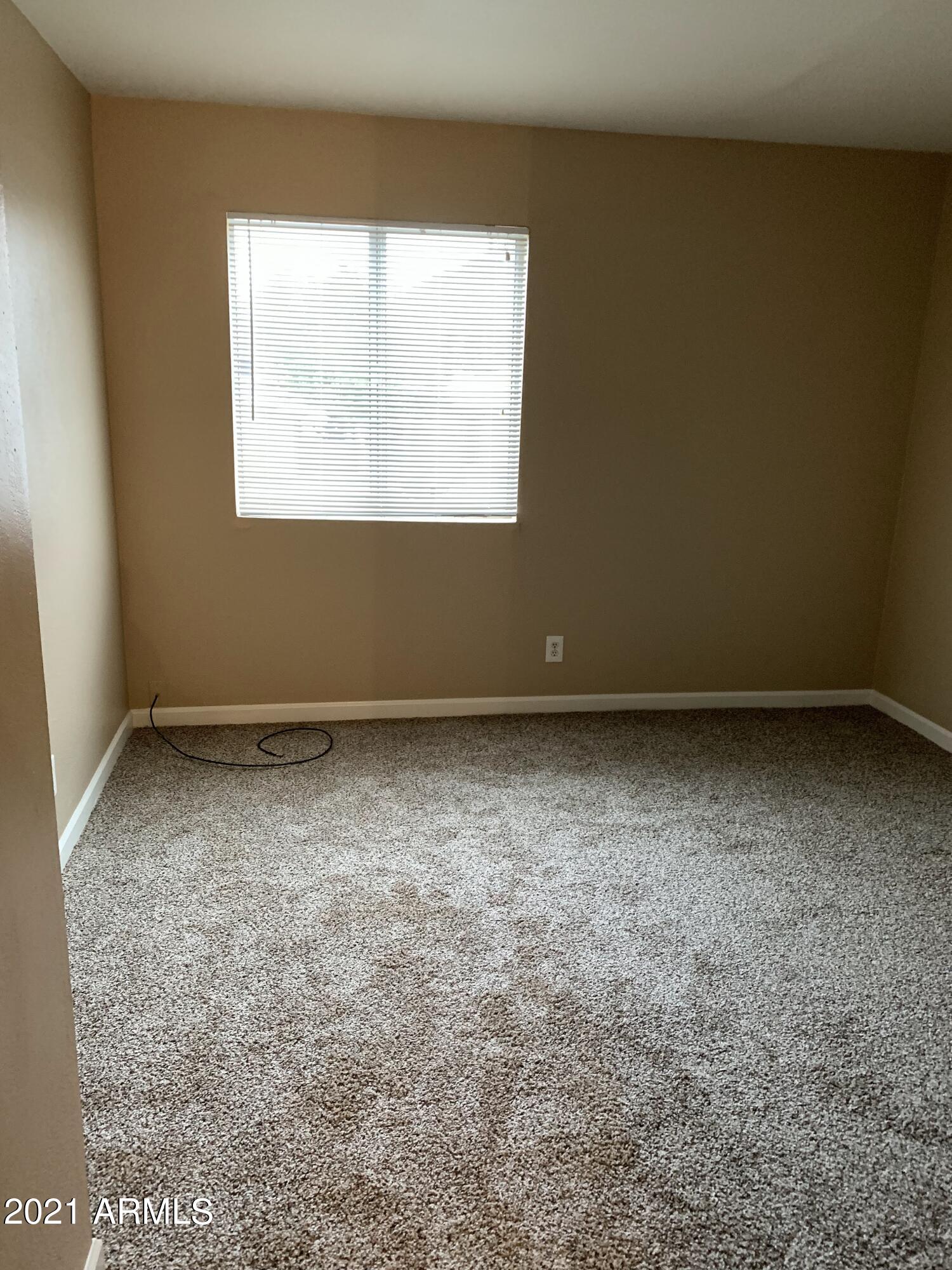 2217 East Cactus Road, Unit 4 Phoenix, AZ 85022 - Photo 13 of 14 an empty room with a window