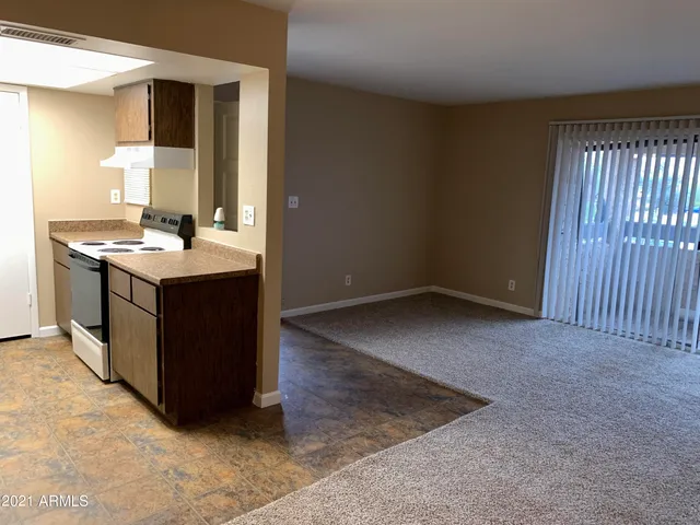 an empty room with a kitchen