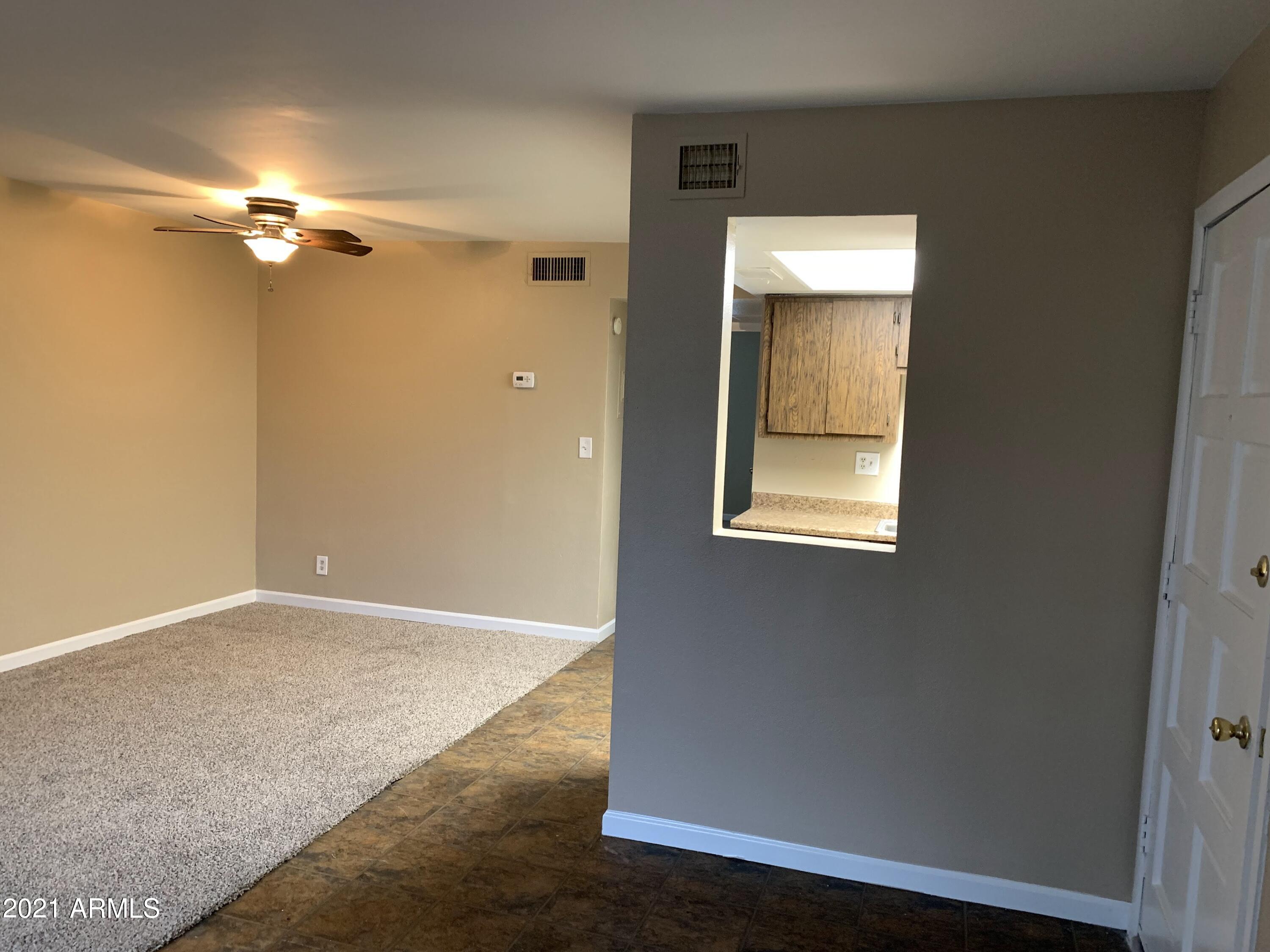 2217 East Cactus Road, Unit 4 Phoenix, AZ 85022 - Photo 9 of 14 an empty room with a windows and closet