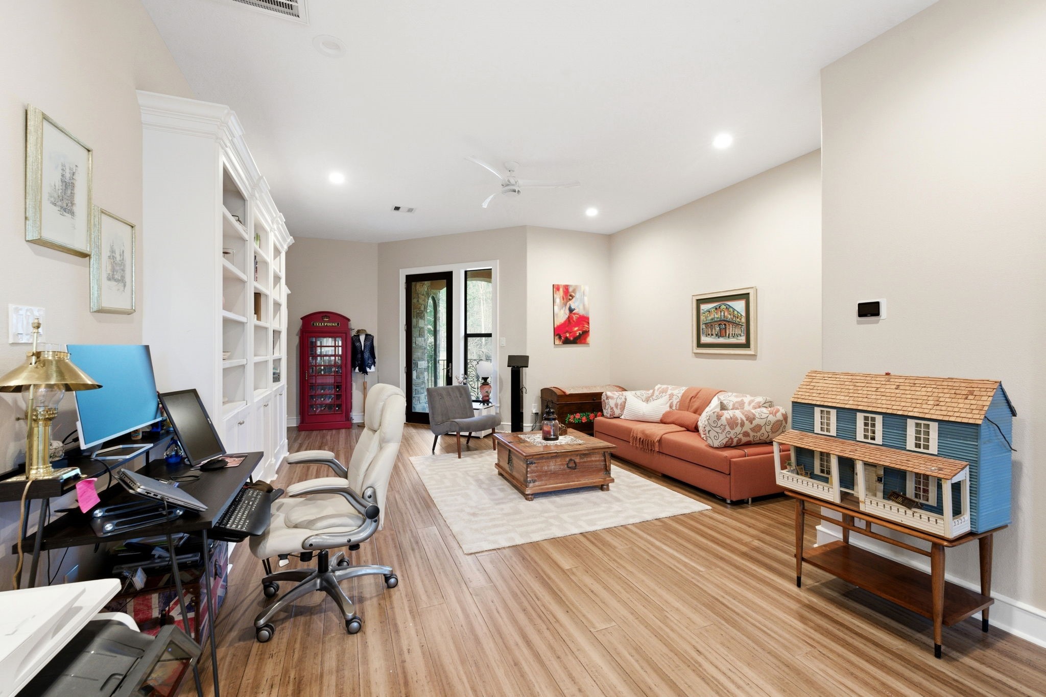 280 Sundog Road Huntsville, TX 77340 - Photo 35 of 50 Alternate view of the upstairs flex space showcasing built-in bookcases, workspace area, and access to a second private balcony.