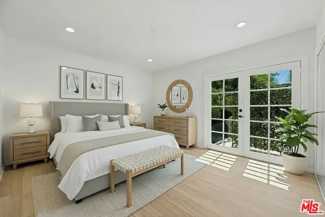 a spacious bedroom with a large bed and a window