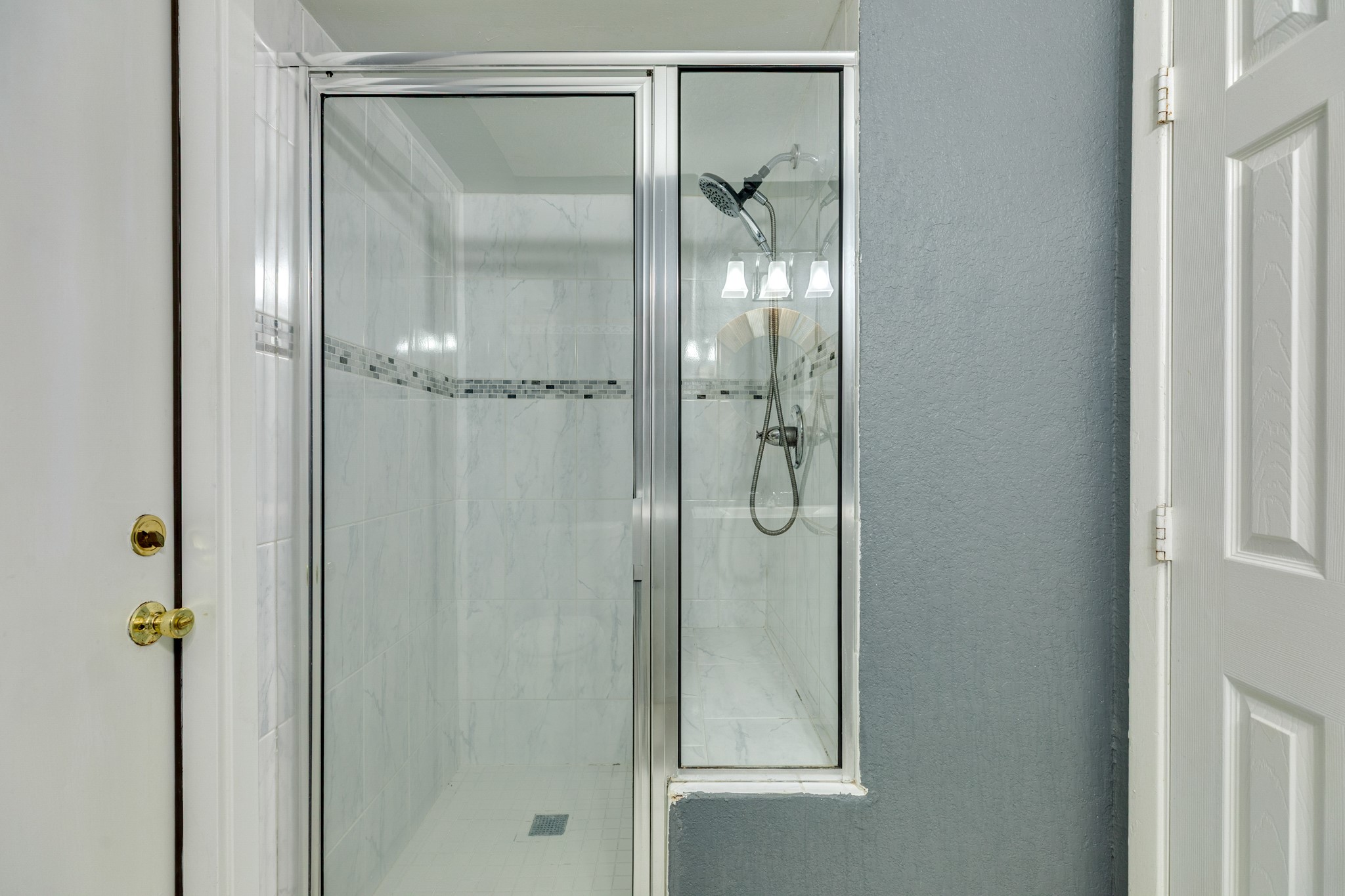 128 Houston Street Angleton, TX 77515 - Photo 20 of 25 a bathroom with a glass shower door