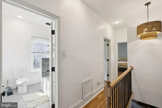a bathroom with a toilet a sink and a mirror