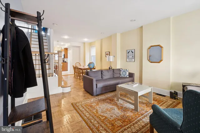 a living room with furniture and a rug