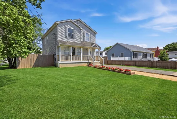 a front view of house with yard and green space