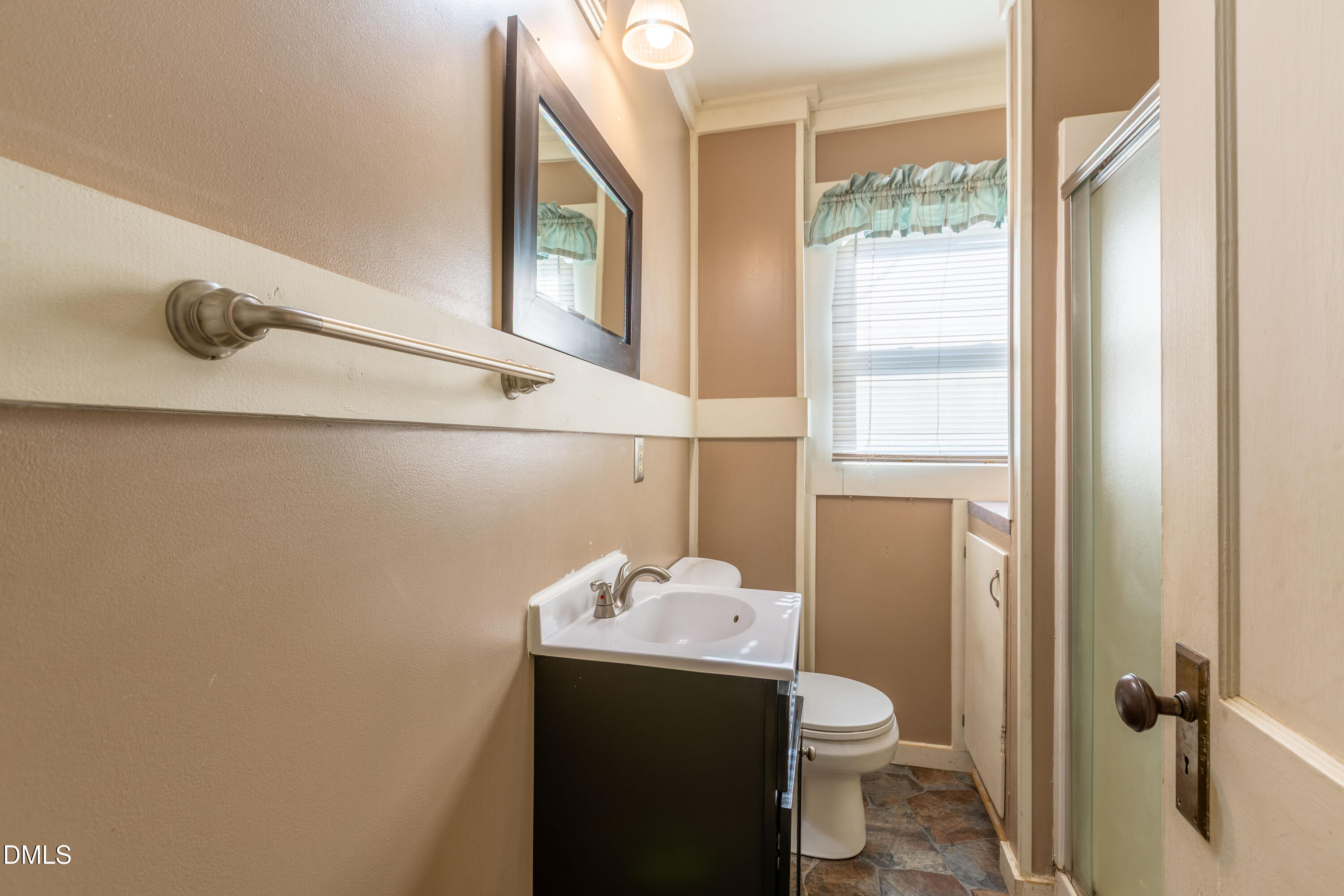 4295 Virgilina Road Roxboro, NC 27574 - Photo 9 of 46 a bathroom with a granite countertop sink toilet and a mirror