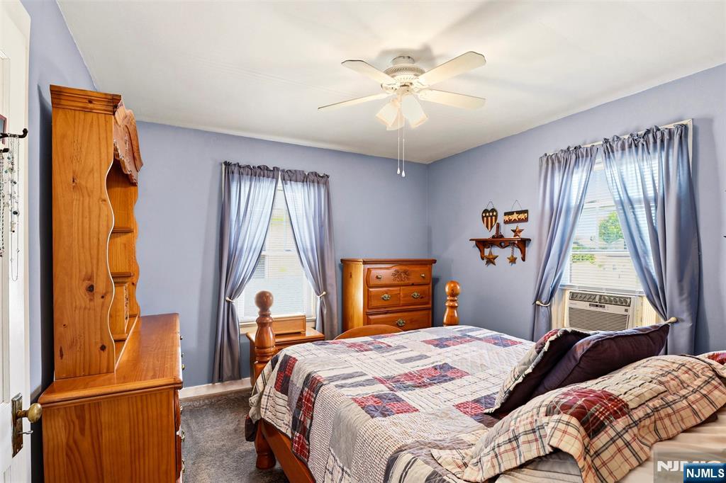 332 Riverside Avenue Lyndhurst, NJ 07071 - Photo 21 of 31 a bedroom with a bed and a chandelier