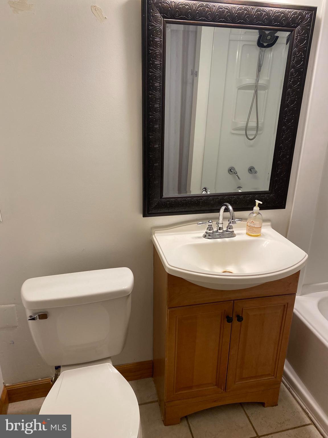 2601 Cool Spring Road Adelphi, MD 20783 - Photo 11 of 22 a bathroom with a toilet sink and mirror