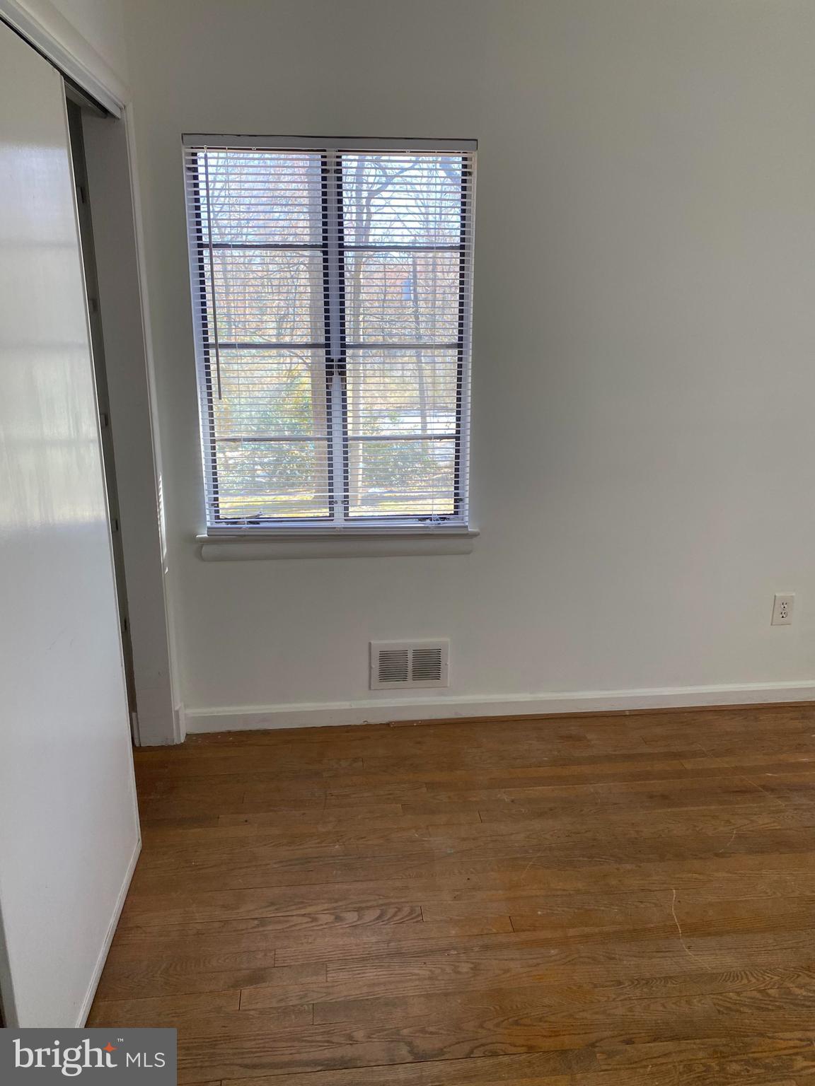 2601 Cool Spring Road Adelphi, MD 20783 - Photo 14 of 22 a view of an empty room with wooden floor and a window