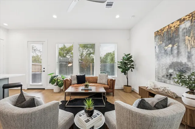 a living room with furniture and a potted plant