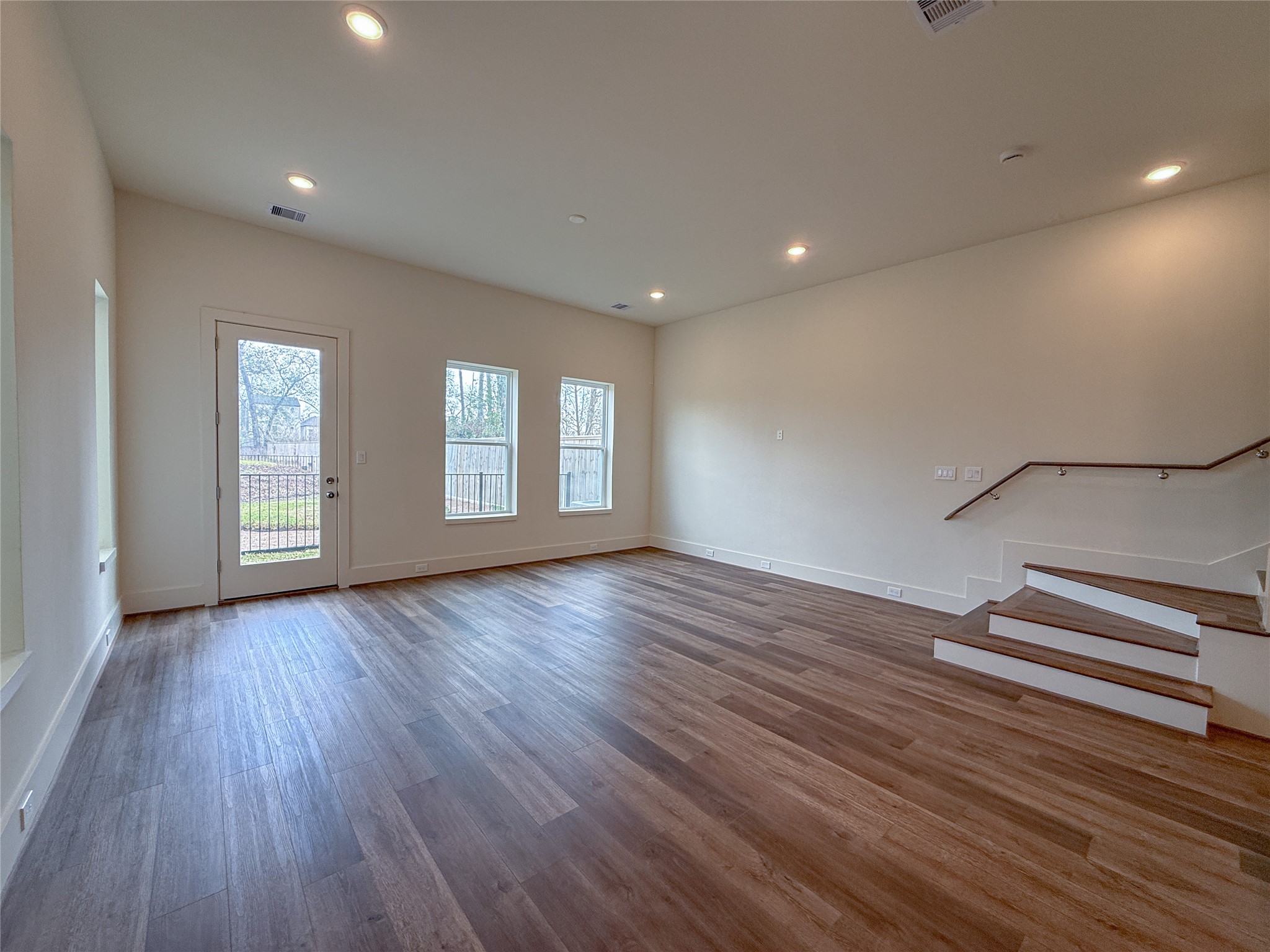 879 Rachel Street, Unit F Houston, TX 77091 - Photo 4 of 23 a view of empty room with wooden floor and window