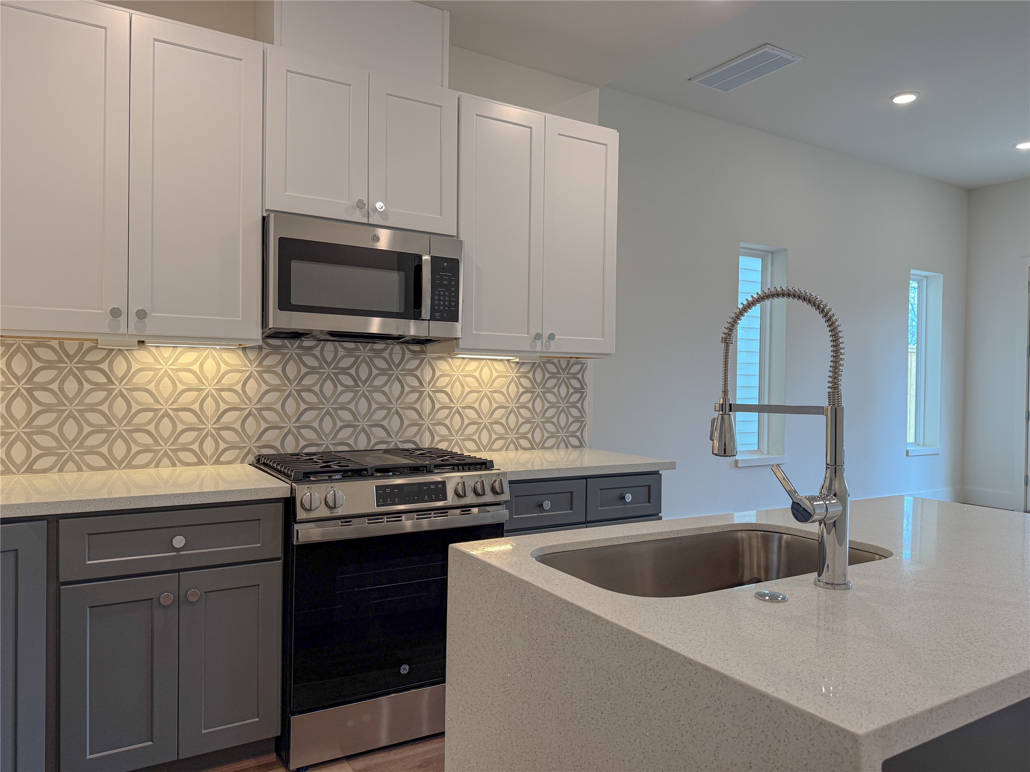 879 Rachel Street, Unit F Houston, TX 77091 - Photo 6 of 23 a kitchen with stainless steel appliances granite countertop a sink stove and microwave