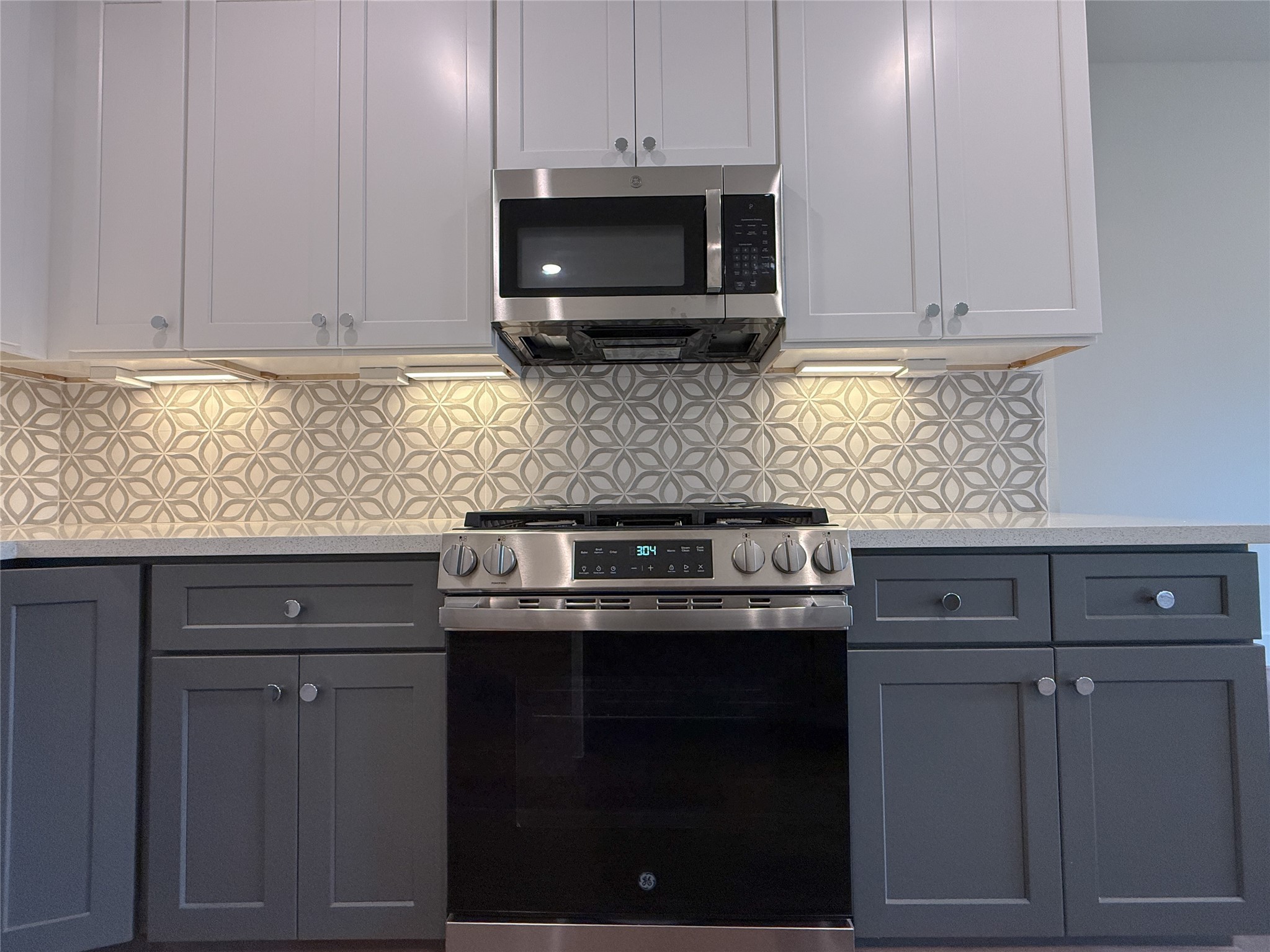 879 Rachel Street, Unit F Houston, TX 77091 - Photo 8 of 23 a kitchen with stainless steel appliances granite countertop white cabinets and a stove top oven