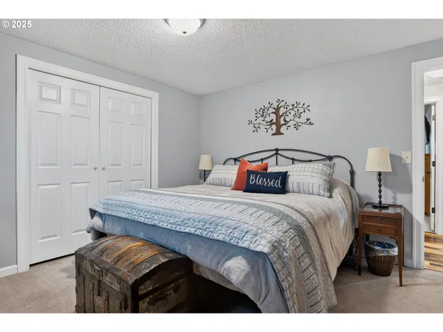 a bedroom with a bed and a night stand