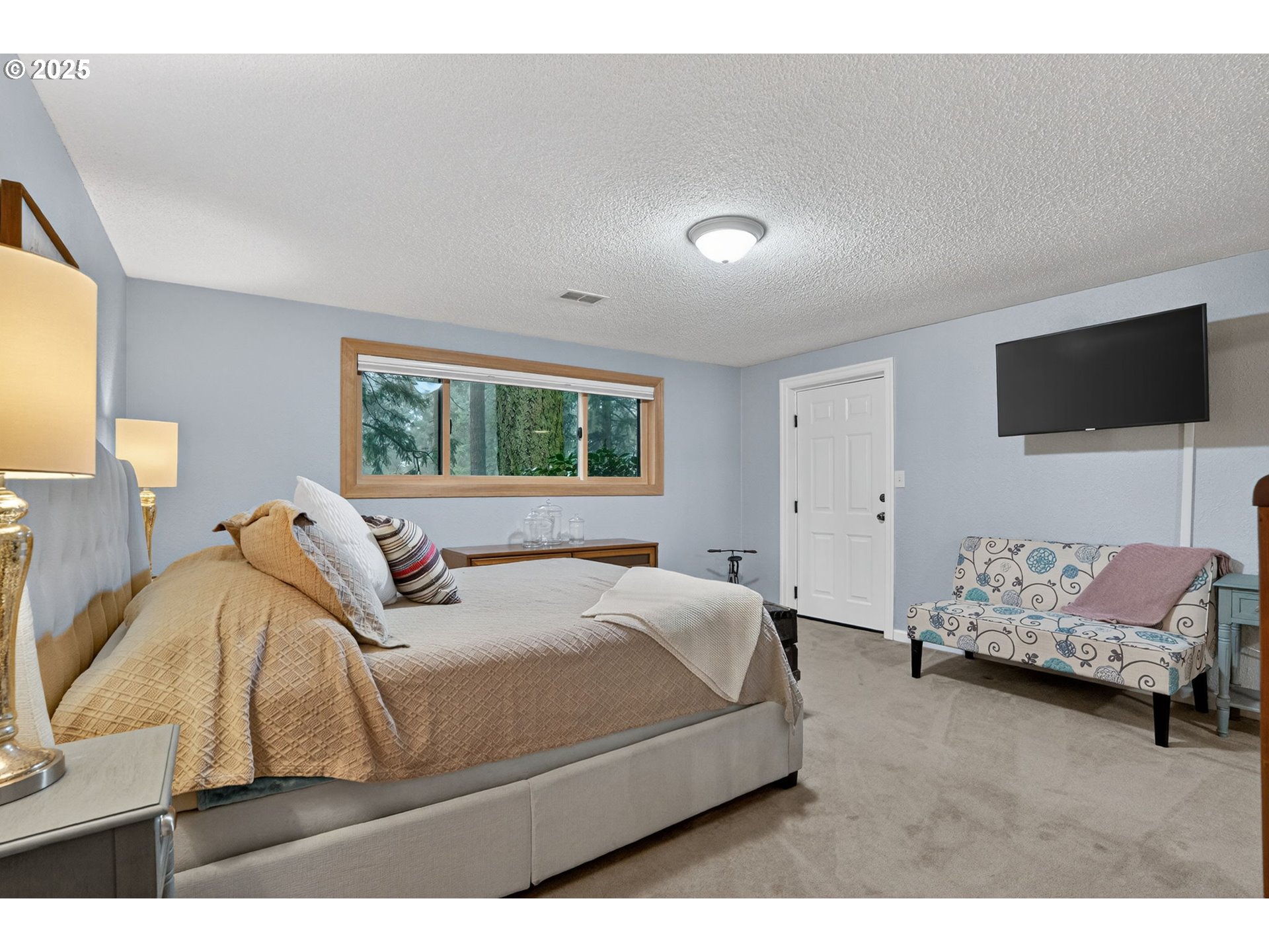 17542 Kirkwood Road Gladstone, OR 97027 - Photo 35 of 48 a bedroom with a bed and a tv