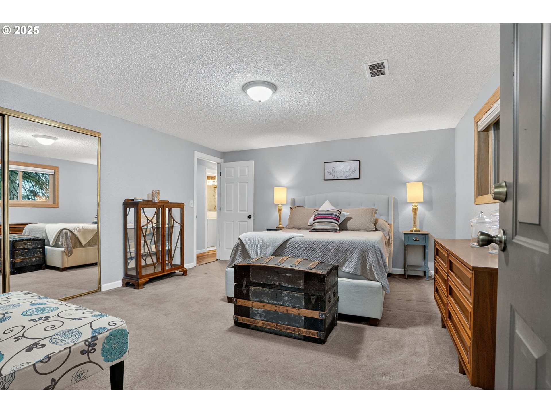 17542 Kirkwood Road Gladstone, OR 97027 - Photo 36 of 48 a spacious bedroom with a bed a couch and dresser