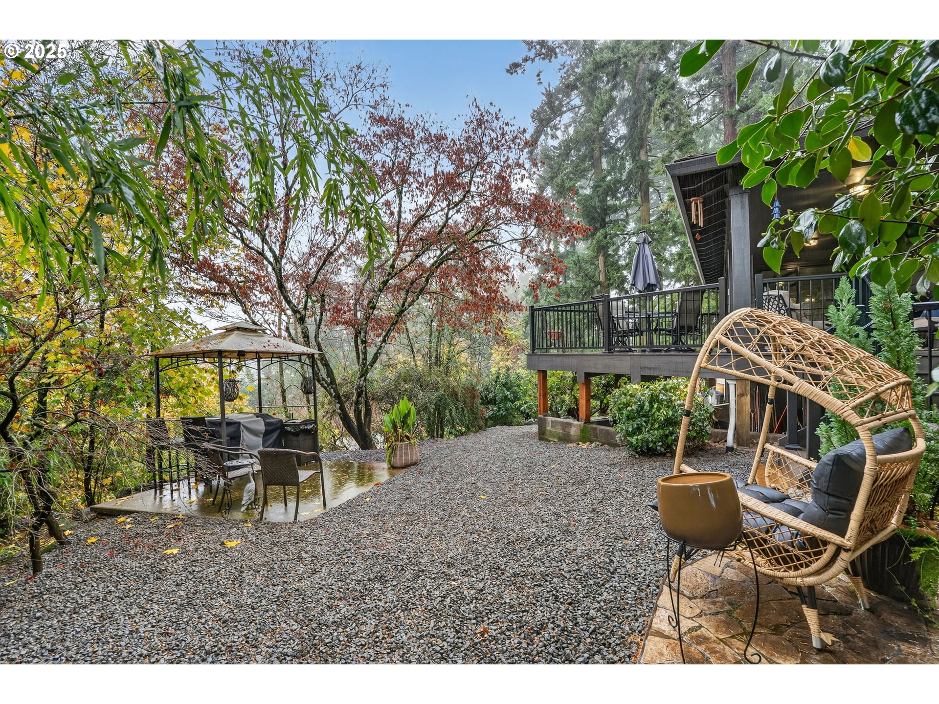 17542 Kirkwood Road Gladstone, OR 97027 - Photo 44 of 48 a view of a patio with table and chairs potted plants and large tree